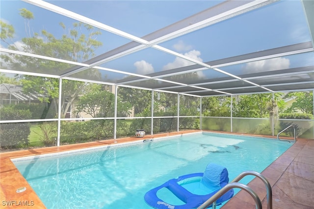 view of swimming pool with glass enclosure