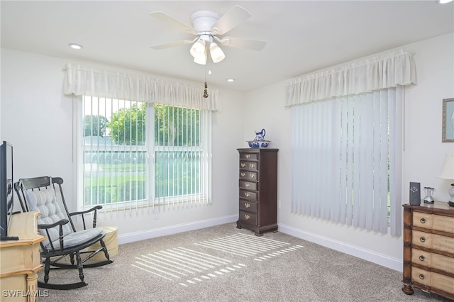 sitting room featuring carpet and ceiling fan