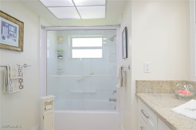 bathroom featuring vanity and tiled shower / bath