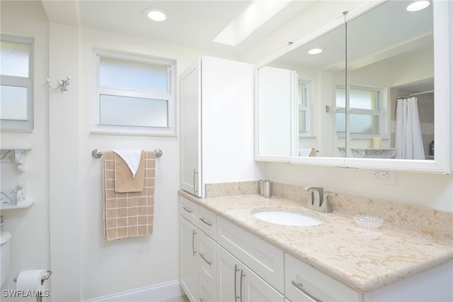 bathroom with vanity and a skylight