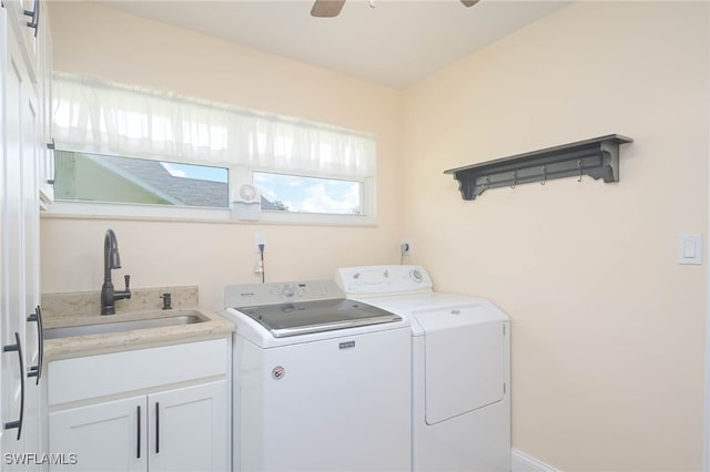 laundry room featuring cabinets, washing machine and dryer, and sink