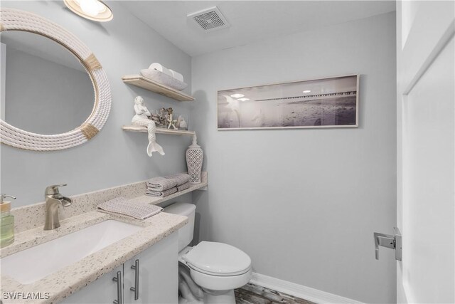 bathroom with vanity and toilet