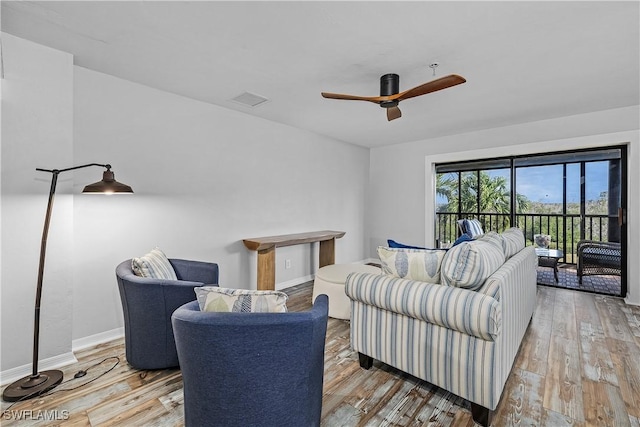 living room featuring hardwood / wood-style floors and ceiling fan