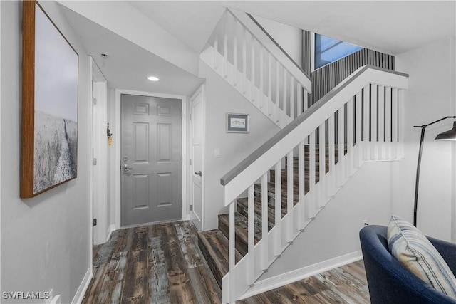 staircase with hardwood / wood-style floors