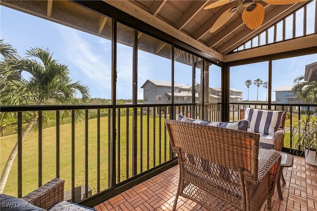 sunroom featuring ceiling fan, wooden ceiling, and vaulted ceiling