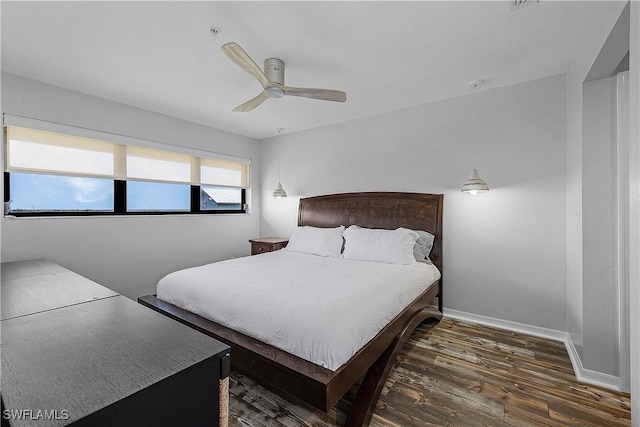 bedroom with ceiling fan and dark hardwood / wood-style floors