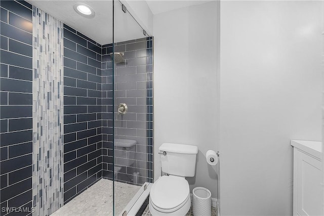 bathroom featuring toilet and a tile shower