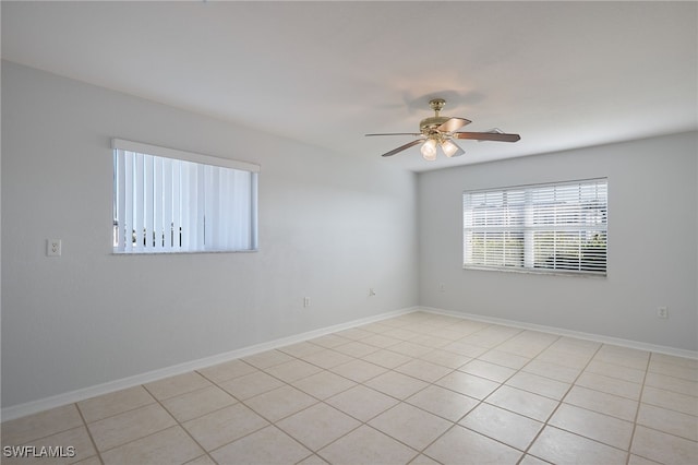 tiled spare room with ceiling fan