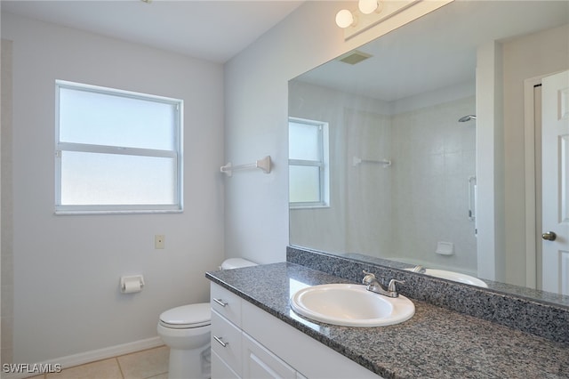 bathroom featuring vanity, tile patterned flooring, a shower, and plenty of natural light