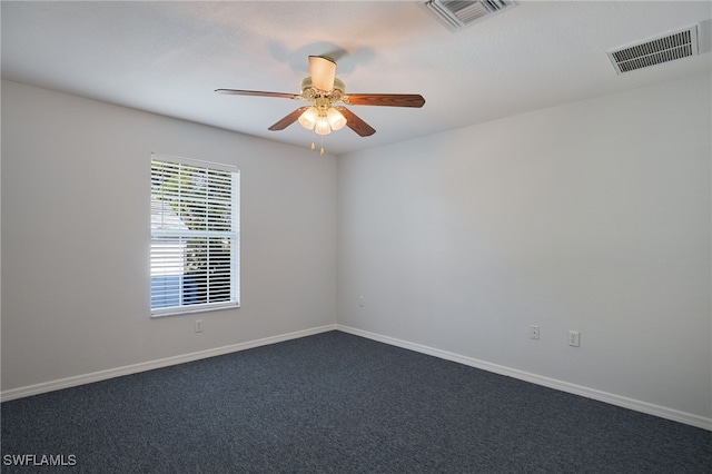 carpeted spare room featuring ceiling fan