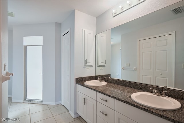 bathroom with tile patterned flooring and vanity