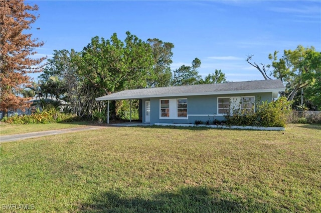 single story home featuring a front lawn and a carport