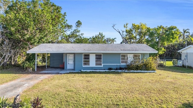 single story home with a front lawn and a carport