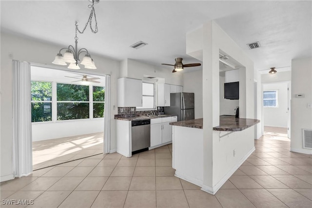 kitchen featuring pendant lighting, light tile patterned floors, appliances with stainless steel finishes, white cabinets, and kitchen peninsula