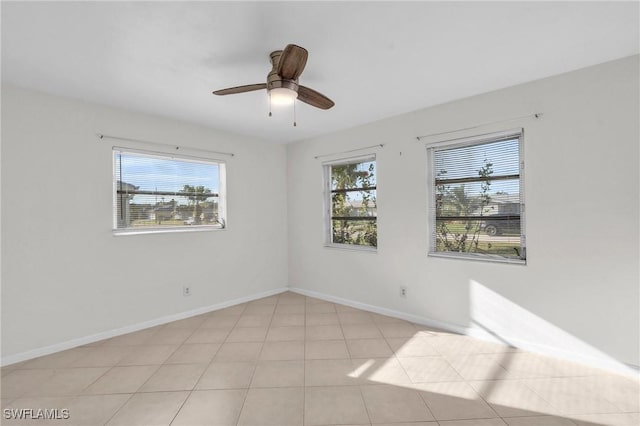 tiled spare room featuring ceiling fan