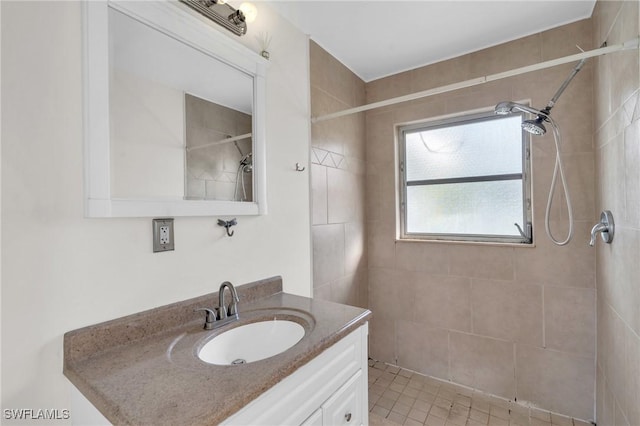 bathroom featuring vanity and tiled shower