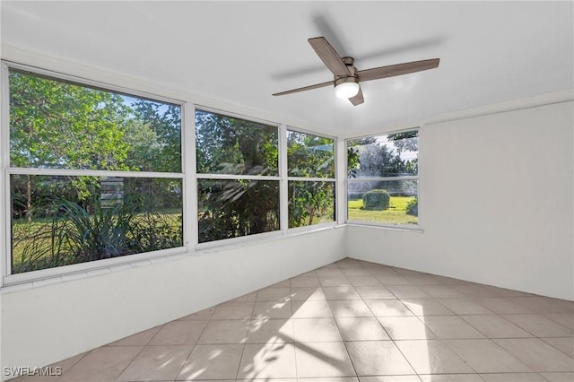 unfurnished sunroom with ceiling fan