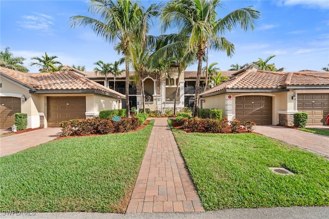 mediterranean / spanish house featuring a garage and a front lawn