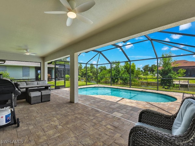 view of swimming pool with outdoor lounge area, ceiling fan, a patio area, and glass enclosure