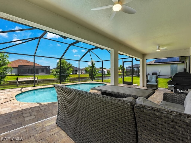 view of swimming pool with a lanai, ceiling fan, and a patio area