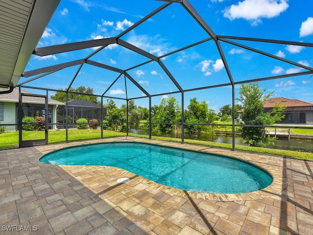 view of pool with a patio, a water view, and a lanai