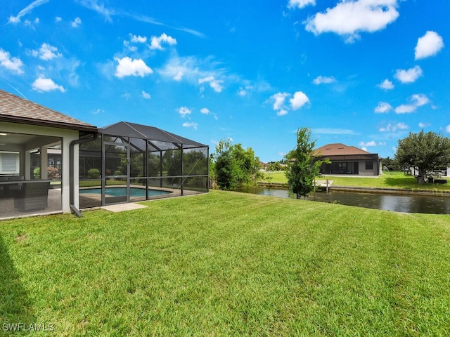 view of yard featuring a lanai and a water view