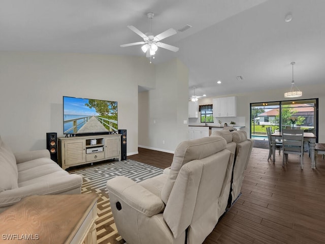 living room with dark hardwood / wood-style floors, high vaulted ceiling, and ceiling fan