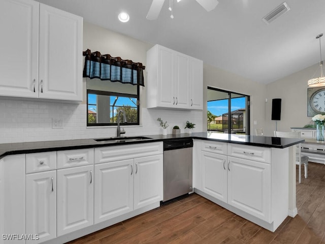 kitchen featuring white cabinets, sink, stainless steel dishwasher, ceiling fan, and kitchen peninsula