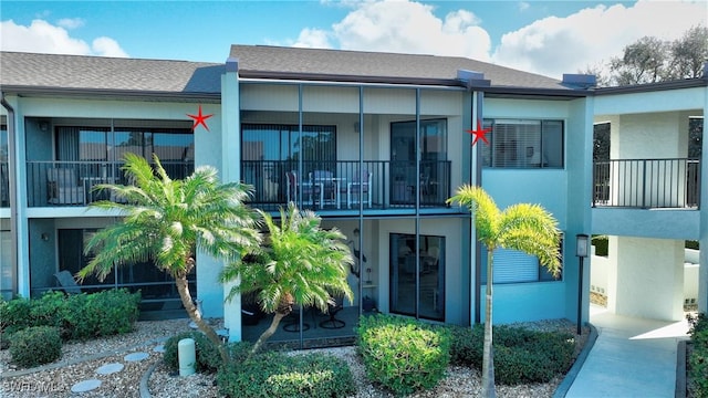 rear view of property featuring a balcony