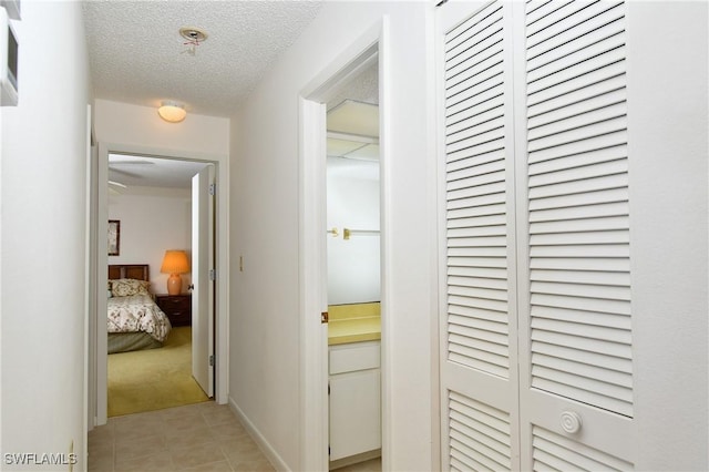 hallway featuring a textured ceiling