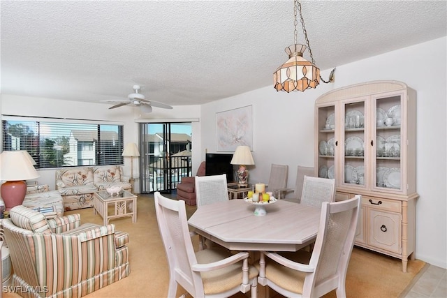 dining room featuring a textured ceiling and ceiling fan with notable chandelier