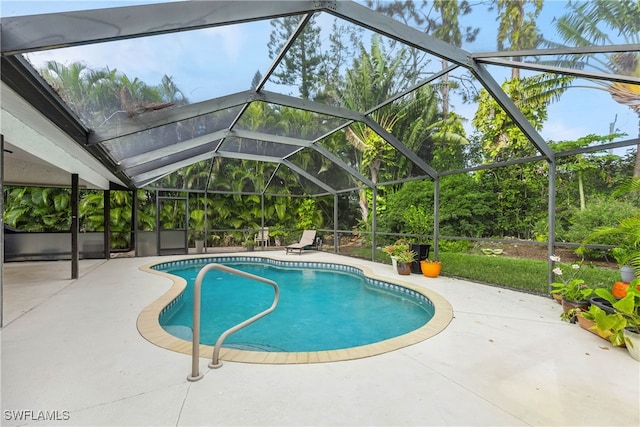 view of swimming pool featuring a lanai and a patio