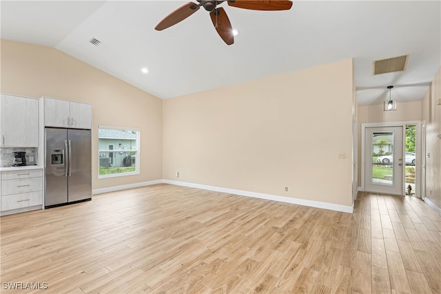 unfurnished living room featuring ceiling fan, light hardwood / wood-style floors, and lofted ceiling