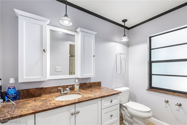 bathroom with crown molding, vanity, and toilet