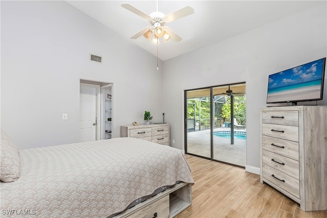 bedroom featuring access to exterior, light wood-type flooring, high vaulted ceiling, and ceiling fan