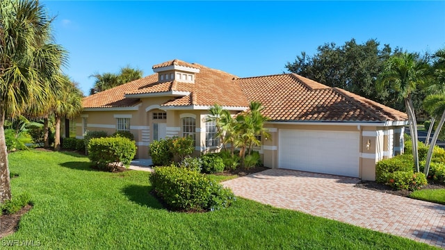 mediterranean / spanish-style house with a garage and a front yard