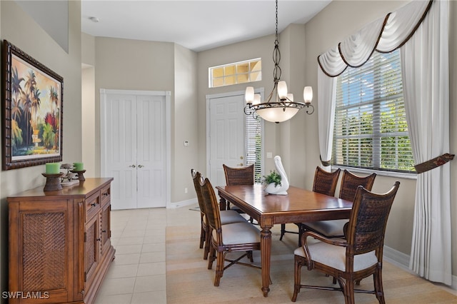 dining space with light tile patterned floors and a notable chandelier