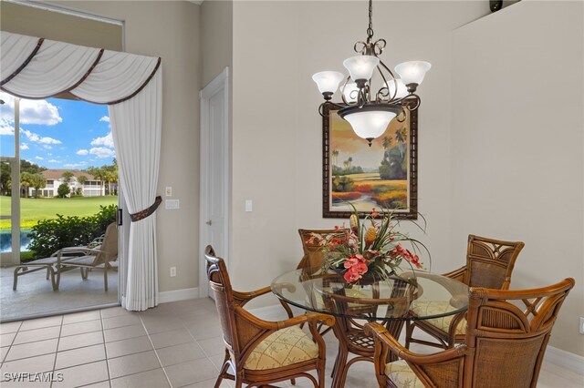 tiled dining space with an inviting chandelier