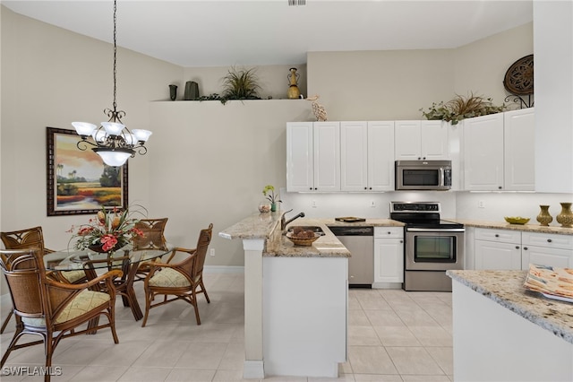 kitchen with white cabinets, hanging light fixtures, a notable chandelier, kitchen peninsula, and stainless steel appliances