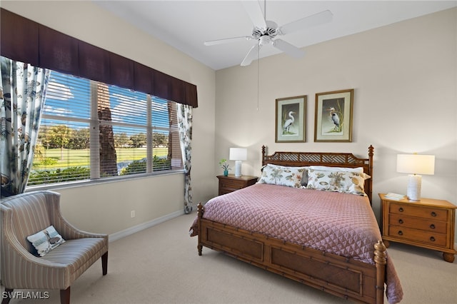 bedroom featuring ceiling fan and light carpet