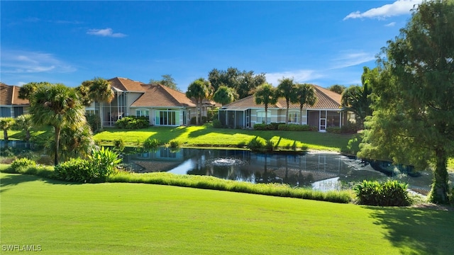 surrounding community with a yard and a water view