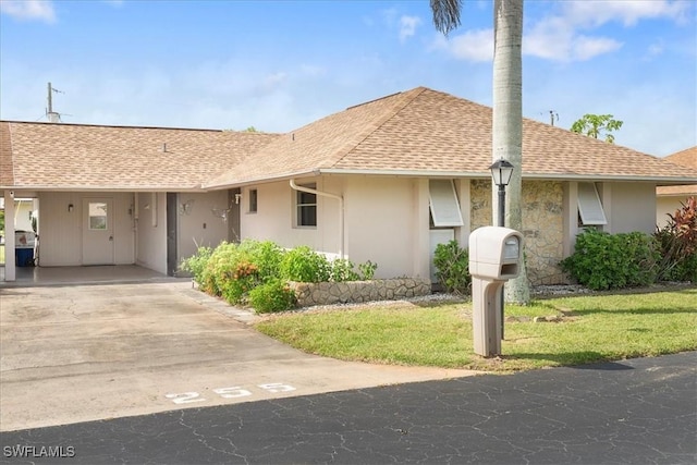 single story home featuring a carport and a front lawn