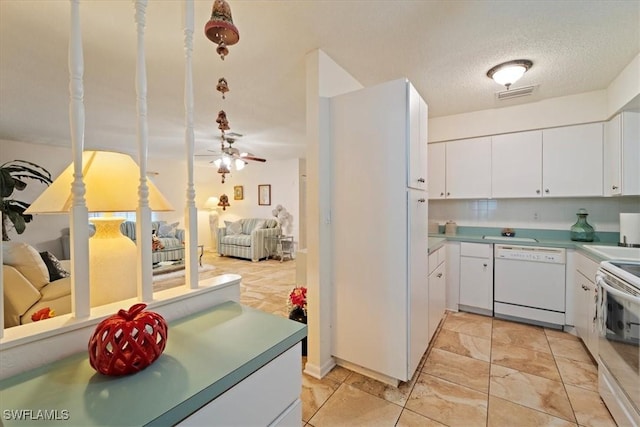 kitchen with white dishwasher, ceiling fan, white cabinetry, and range