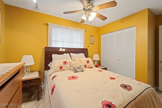 bedroom with ceiling fan and a closet