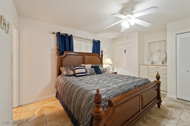 bedroom featuring ceiling fan and a textured ceiling