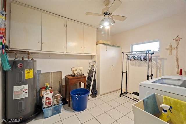 laundry room featuring cabinets, electric water heater, ceiling fan, light tile patterned floors, and washer / dryer