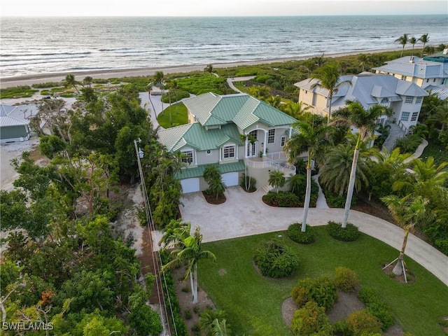 birds eye view of property featuring a water view and a view of the beach