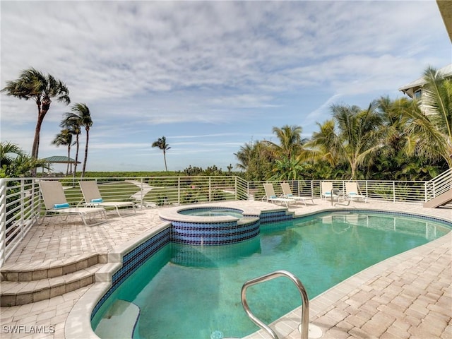 view of swimming pool featuring a patio and a pool with connected hot tub