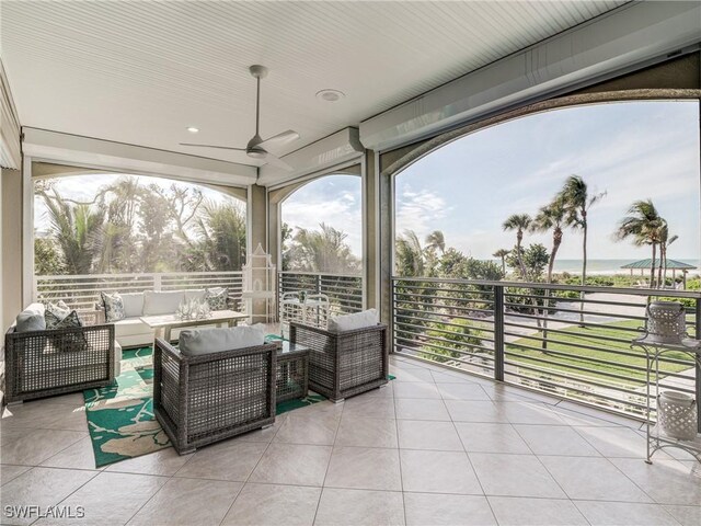 view of patio with a ceiling fan, a balcony, and an outdoor living space