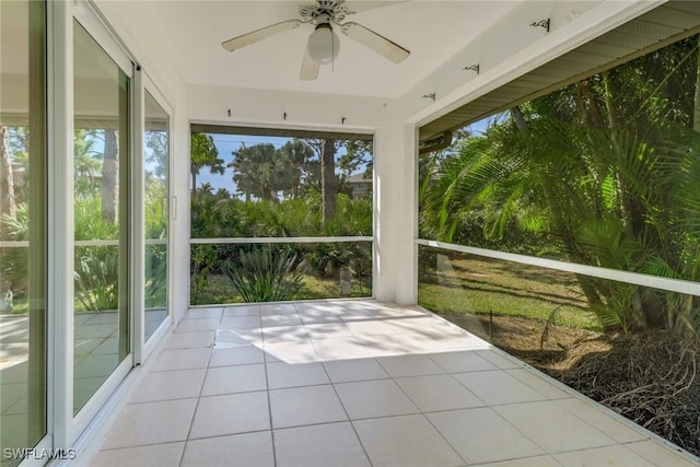 unfurnished sunroom featuring ceiling fan